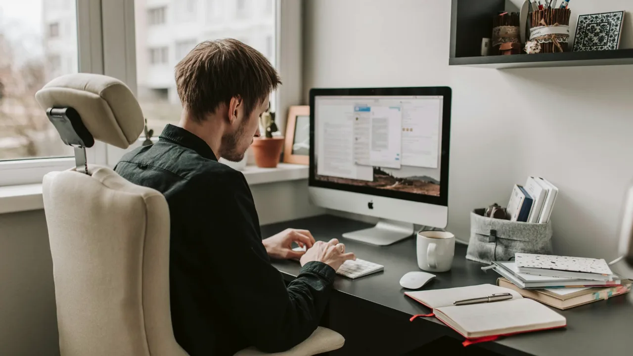 A man working at a computer in a home office