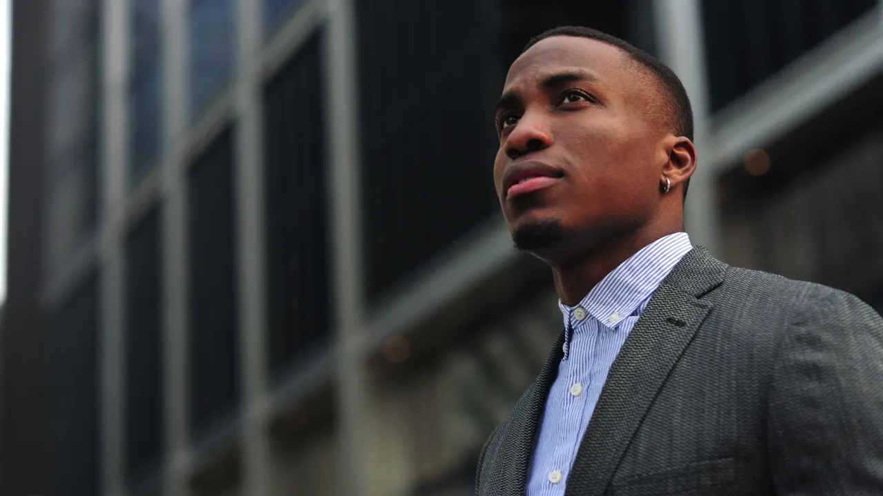 A man in a suit looking ahead with confidence