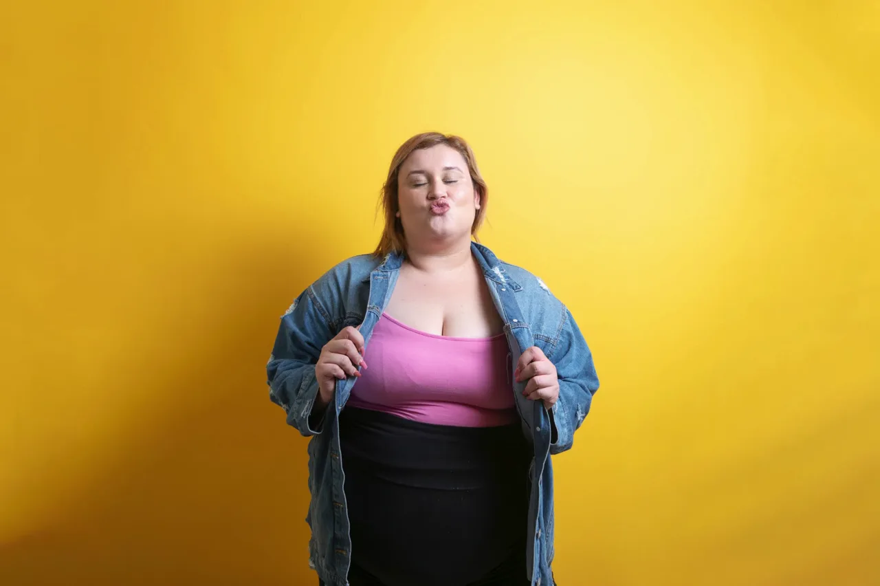 A smiling woman against a yellow background